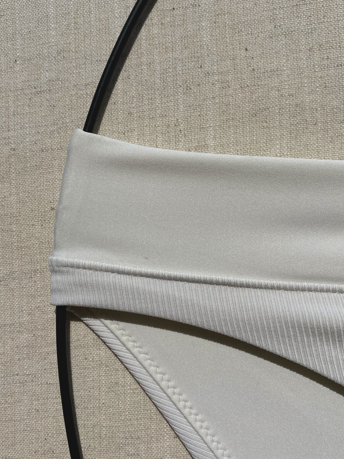 Bikini-bottom-classic-ivory-white-with-rib-fabric-and-embroidery-waistband-close-up