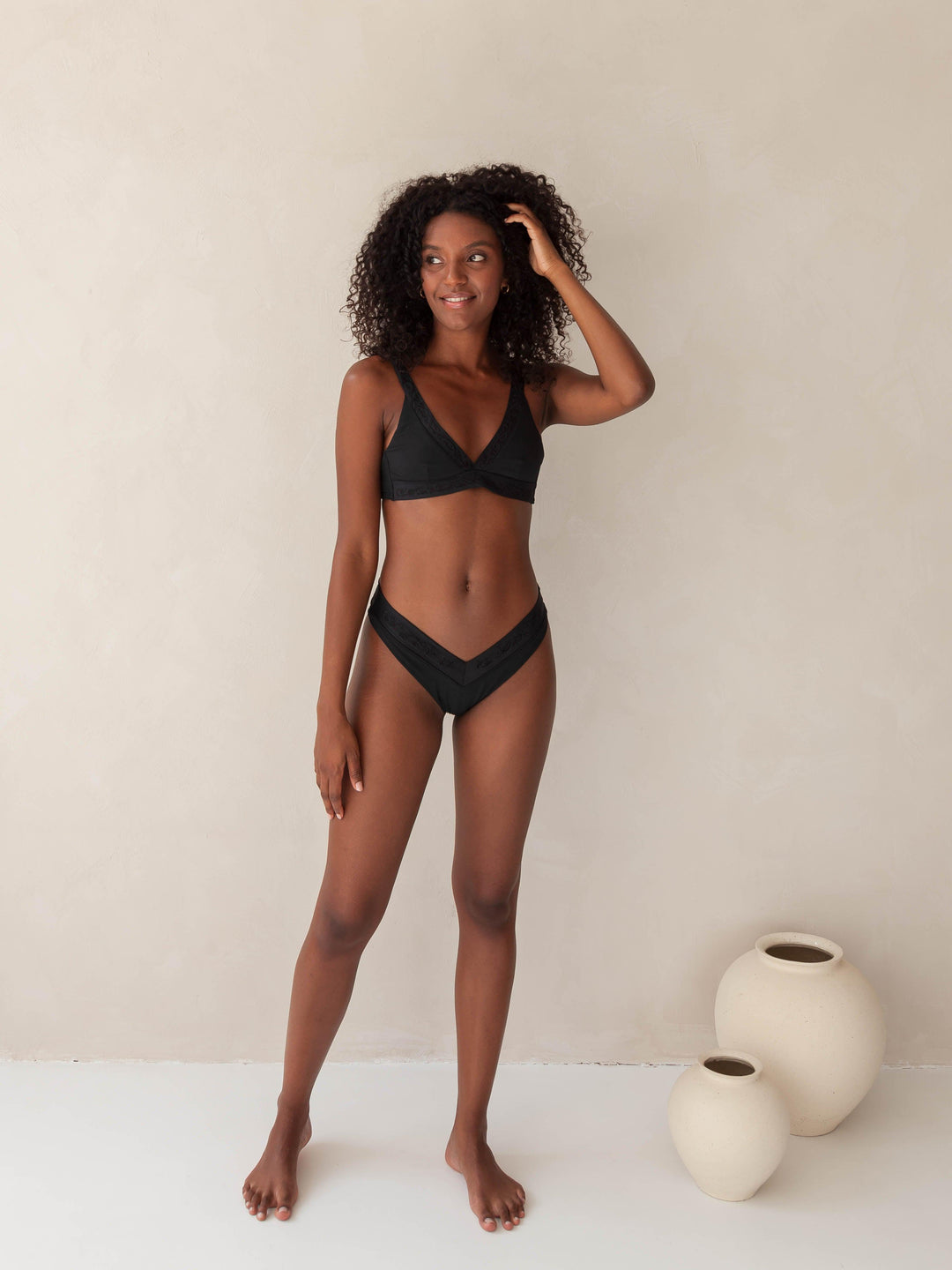Bikini top Plunge V-neck and V-Shape bottom in black with rib fabric and embroidery, woman front