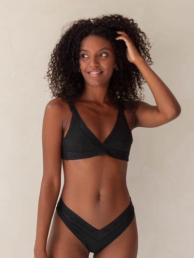 Bikini top Plunge V-neck and V-Shape bottom in black with rib fabric and embroidery, woman torso