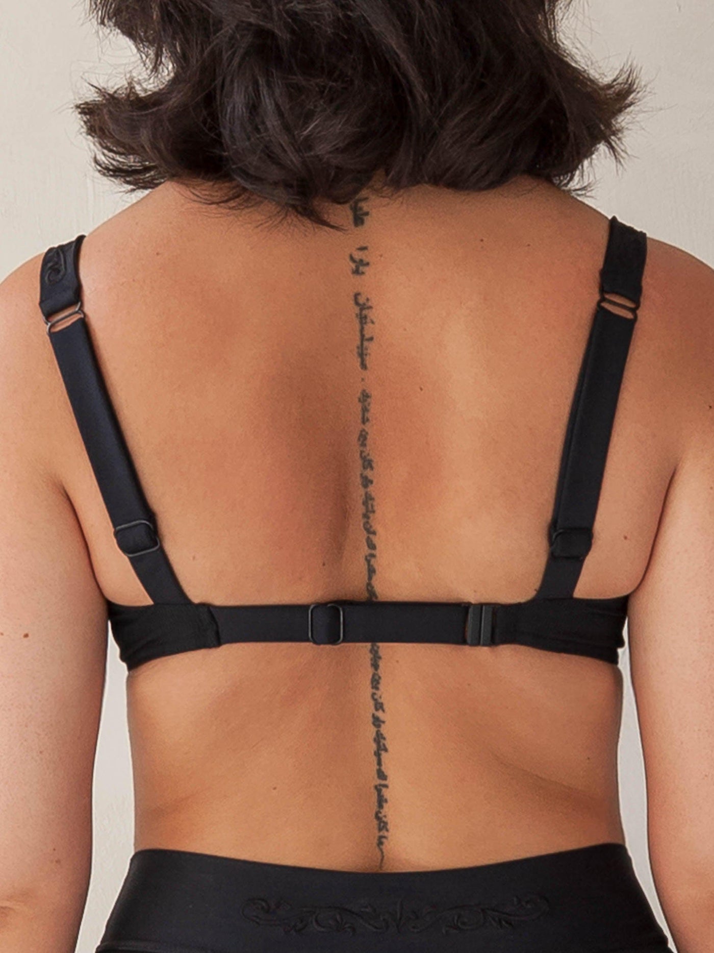 Bikini top with underwire in black, adjustable band size and shoulder straps, backside