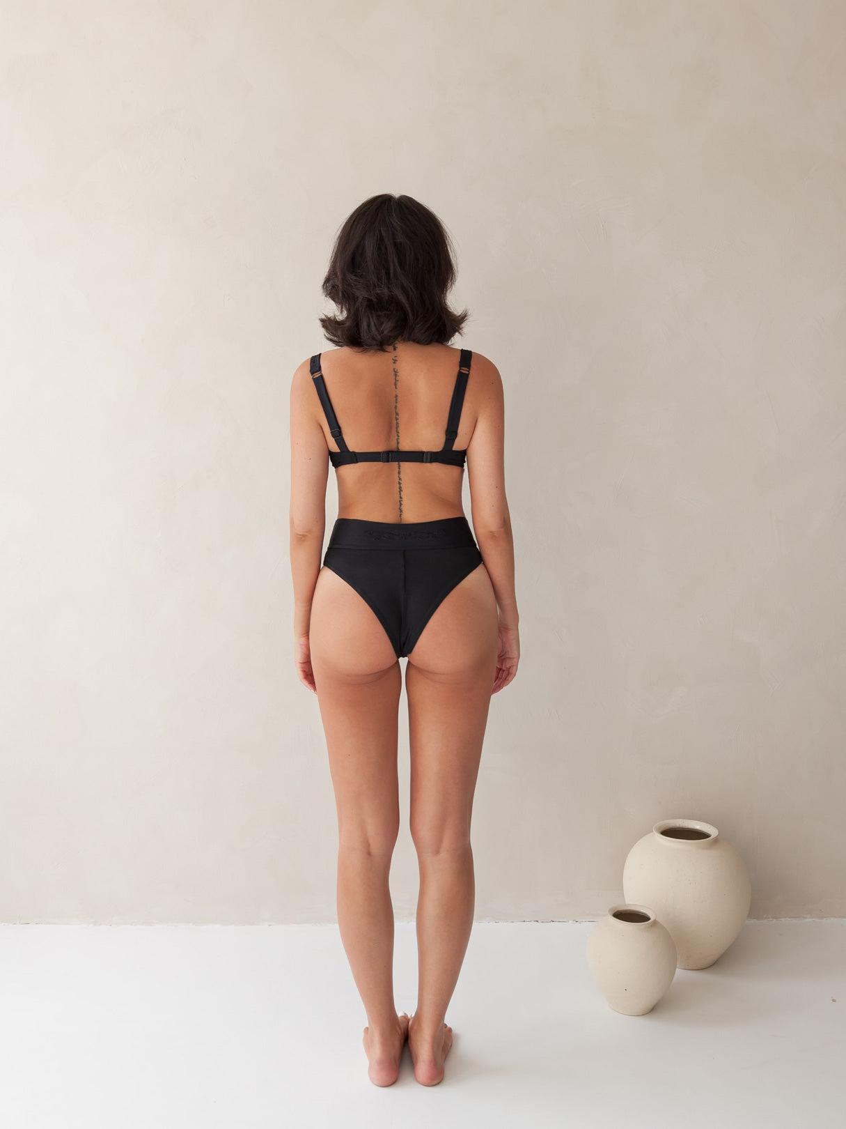 Bikini top balcony underwire and cheeky bikini bottom high-waist in black with rib fabric & embroidery, woman back