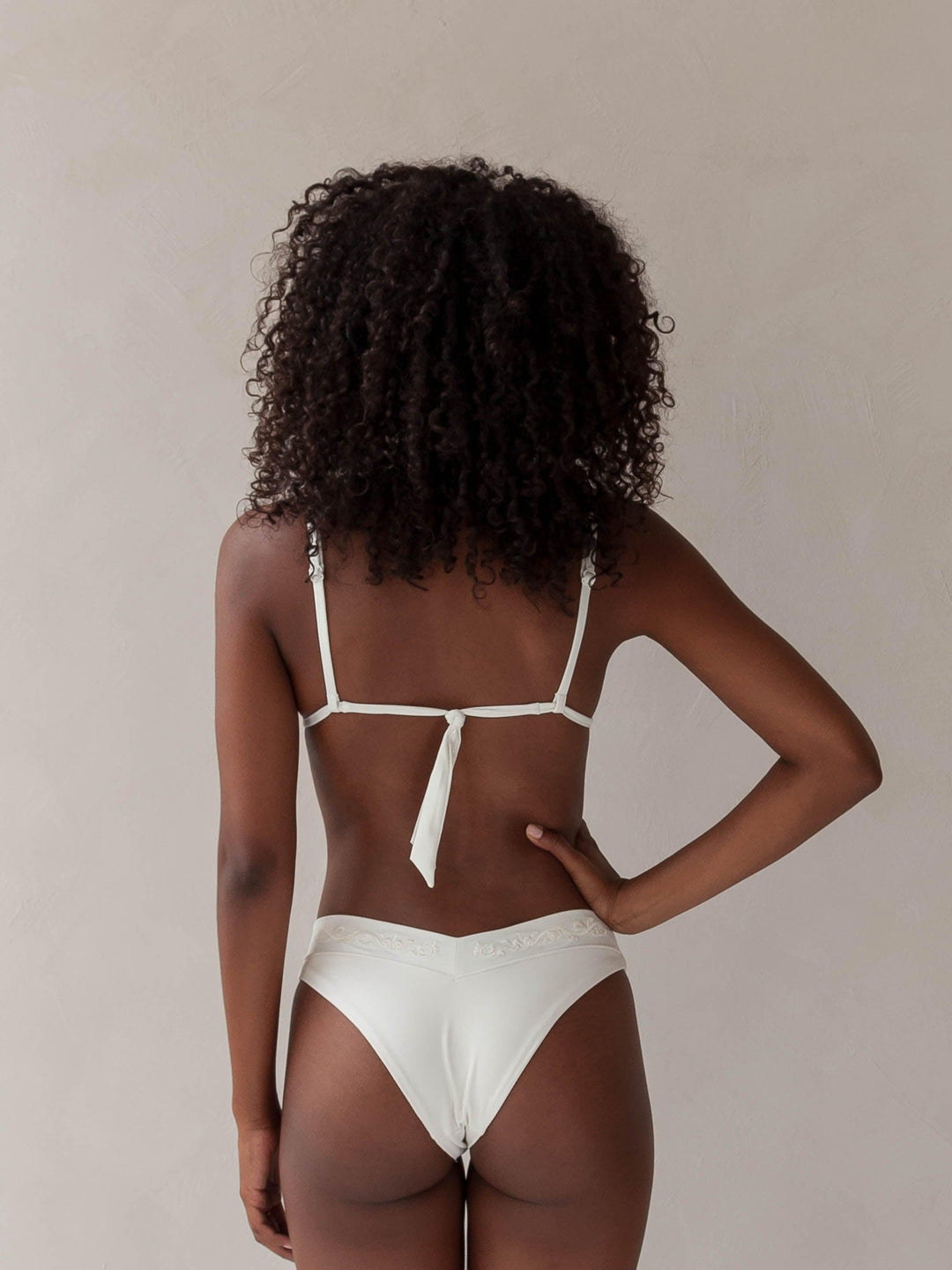 Bikini top triangle and cheeky bikini brazilian tanga bottom in white with rib fabric & embroidery, woman backside