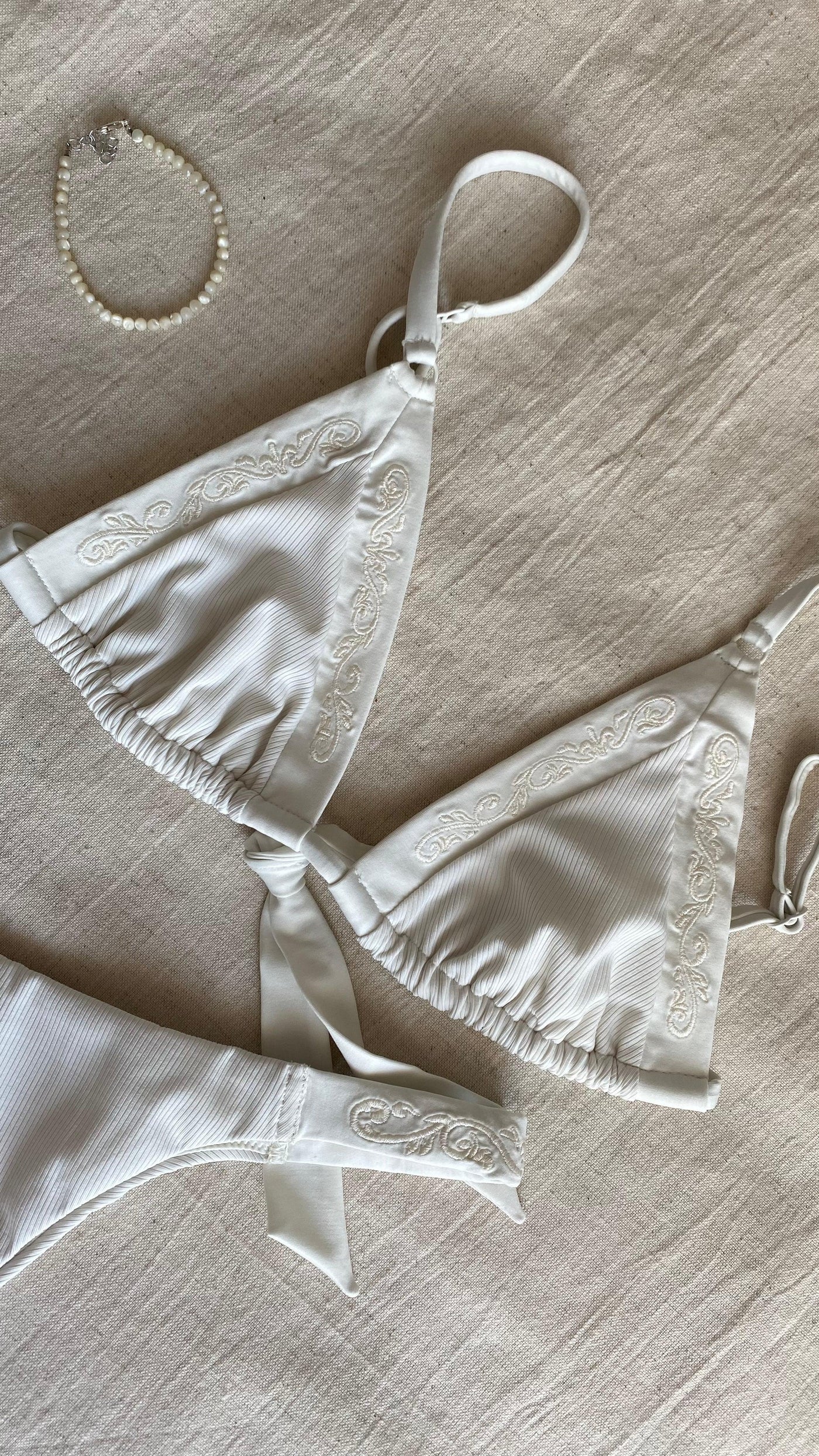 Bikini top triangle with brazilian tanga bottom in ivory-white with rib fabric and embroidery