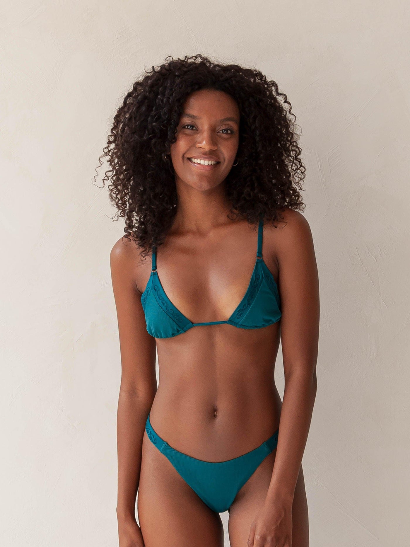 Bikini top triangle and brazilian tanga bottom in green with rib fabric and embroidery, woman front
