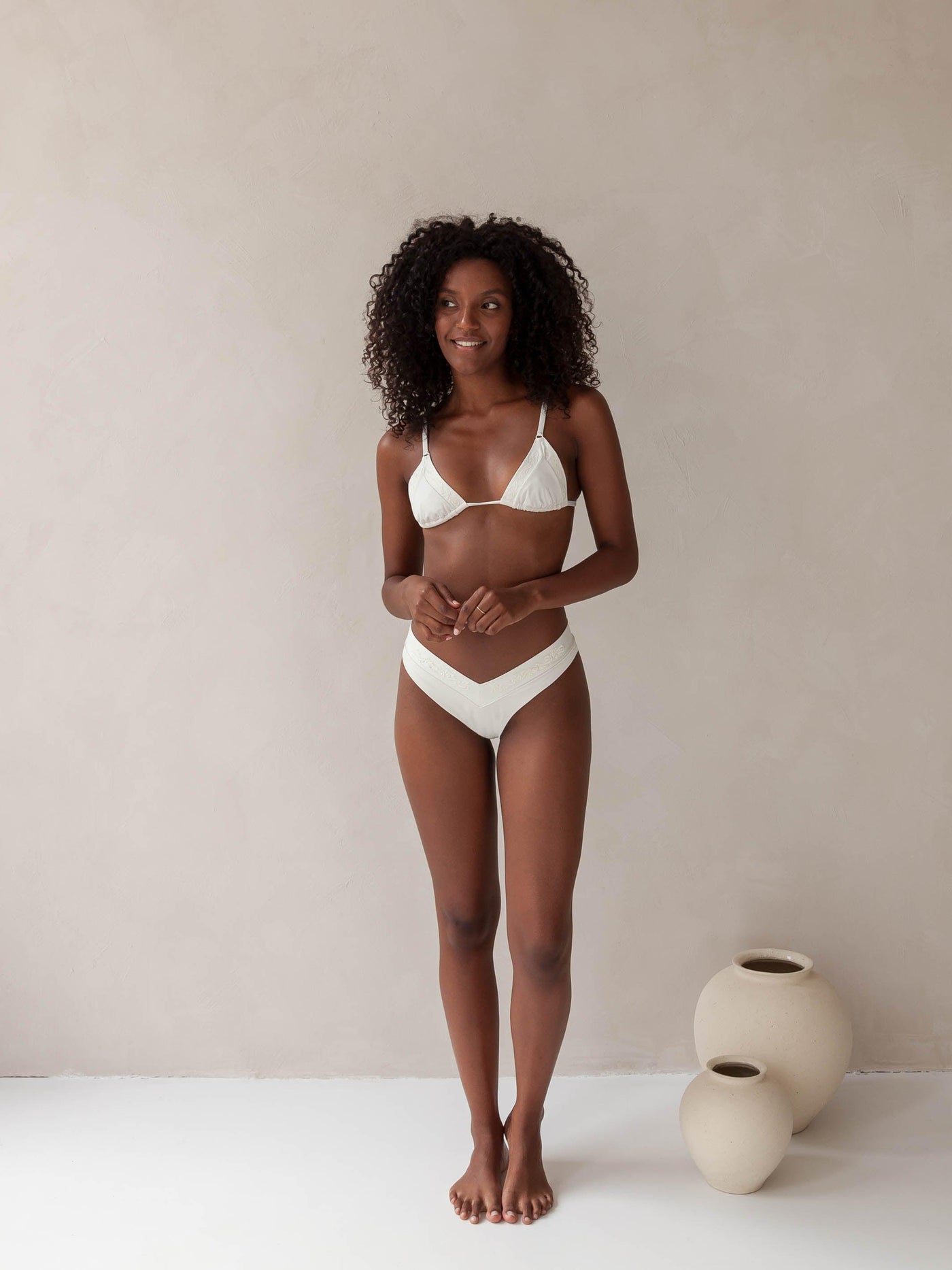 Bikini top triangle and brazilian tanga bottom in white with rib fabric and embroidery, woman front full body
