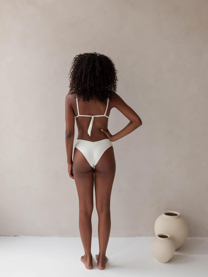 Bikini top triangle and brazilian tanga bottom in white with rib fabric and embroidery, woman back