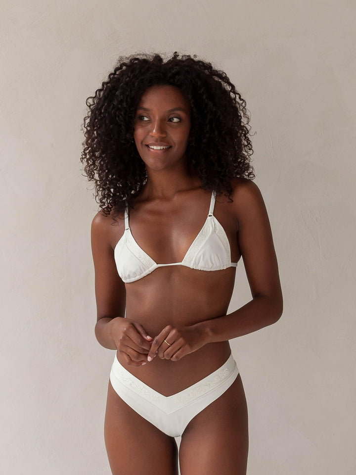 Bikini top triangle and brazilian tanga bottom in white with rib fabric and embroidery, woman front