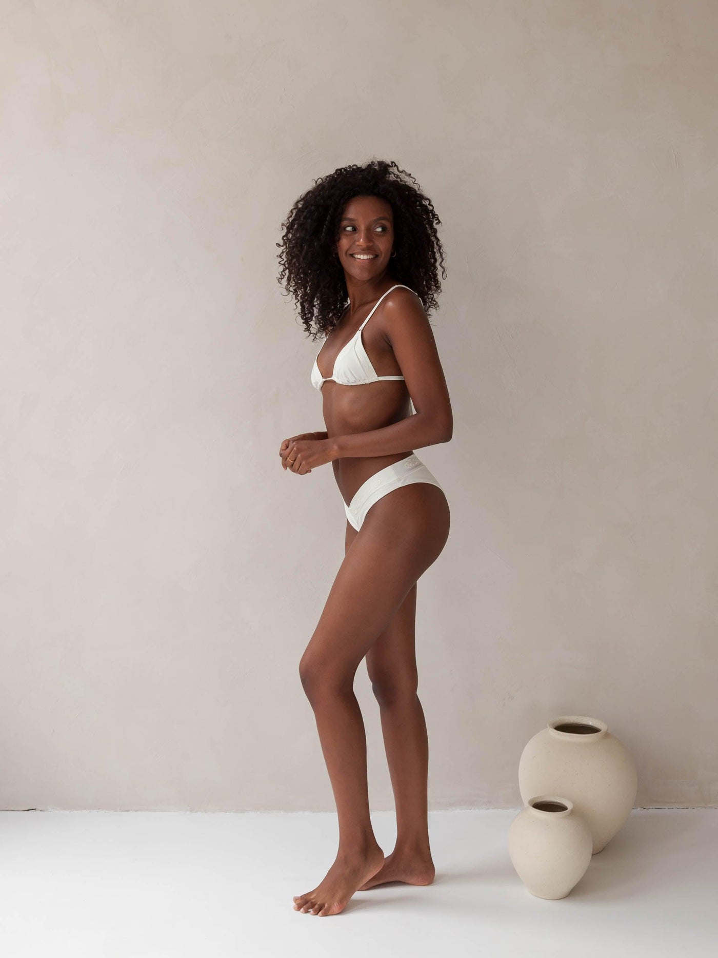 Bikini top triangle and brazilian tanga bottom in white with rib fabric and embroidery, woman side full body